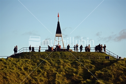 Tourists on Mt Eden lookout, Auckland, New Zealand (foreground focus).
