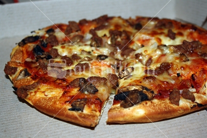Take away pizza, on corrugated cardboard box / tray