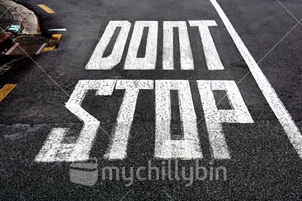"Dont Stop" sign painted on the road. (modified image)