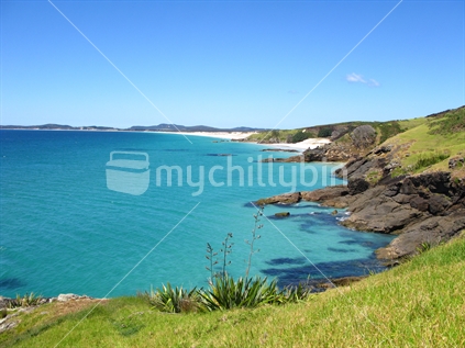 Peaceful Puheke Beach from shoulder of hill, horizontal.