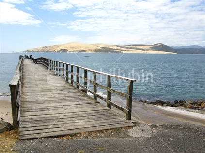 Old wooden wharf at Omapere, opposite sand dunes, Hokianga Harbour, Northland