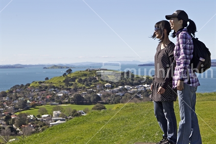 Two Asian girls looking across scene from Mt Victoria, Devonport