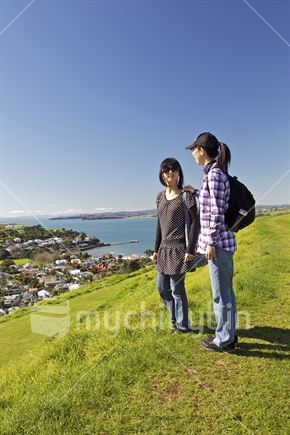 Two Asian girls looking across scene from Mt Victoria, Devonport