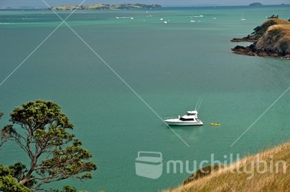 Cove with a boat at anchor, Waiheke Island (foreground focus)