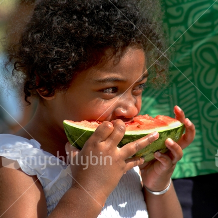 Young girl enjoying a watermelon treat