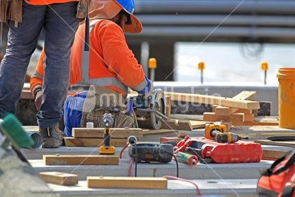 Men at work in HiVis vests on building construction site
