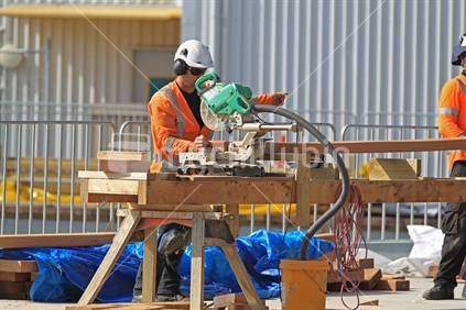 Men at work in HiVis vests on building construction site