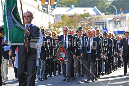 ANZAC day parade with returned servicemen and woman march RSA with wreath