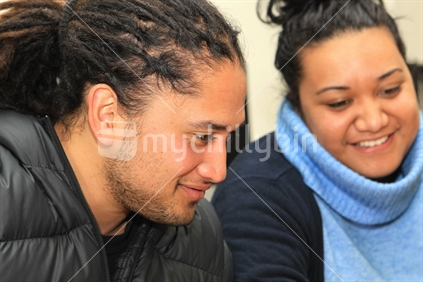 Two Maori university students engaged in learning 