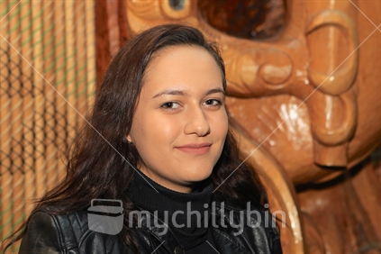 A female Maori university student - background cultural design