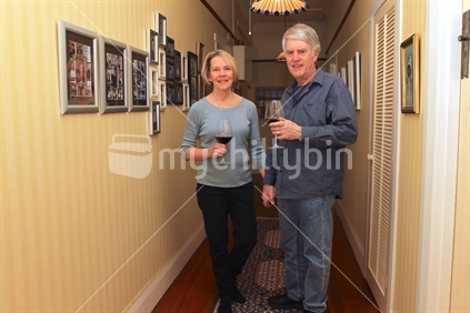 Senior Couple inside hallway with wine glasses