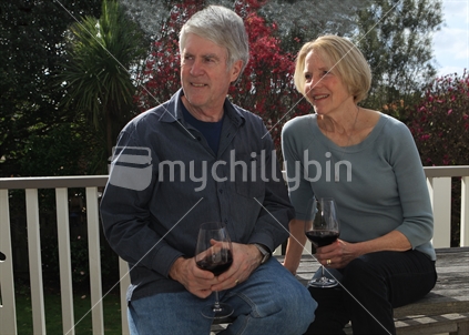 Seniors outside relaxed with wine glass