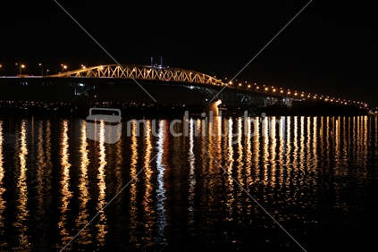 Auckland Harbour Bridge at night with water reflections
