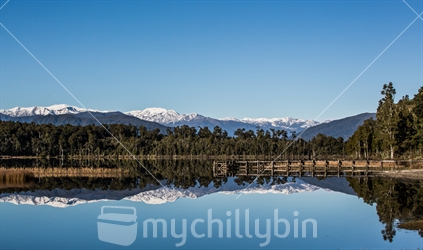 Southern Alps reflected in a a lake.