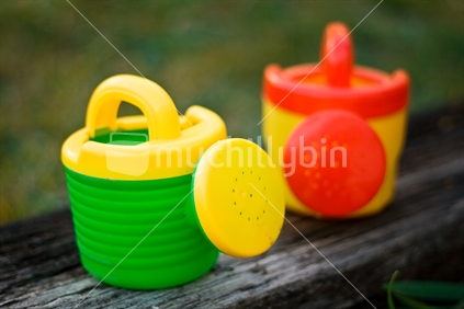 Two toy watering cans.