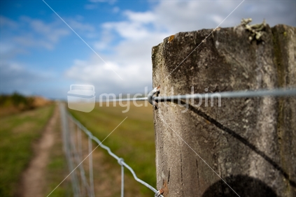 Down the wire; post and wire fence.