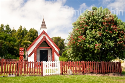 Historic Onuku Maori Church with Pohutukawa Tree in full bloom.