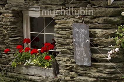 This is a small stone cottage on display in the historic setting of Arrowtown, Otago.