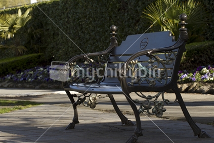 An ornate cast iron bench seat, in Mona Vale. 