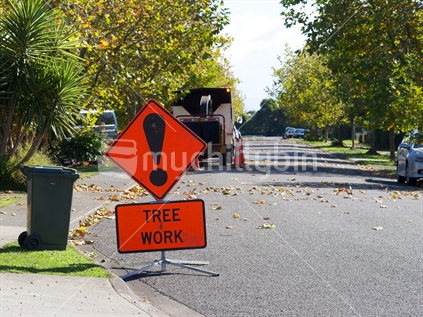 A sign warning motorist of a tree pruning operation in a suburban street