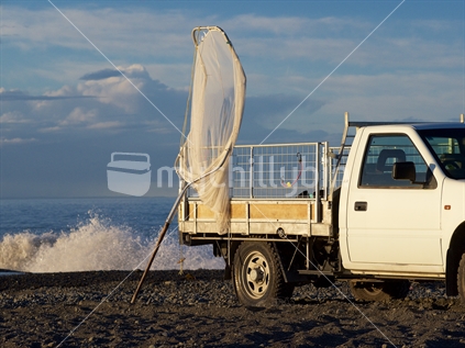 Whitebaiter's truck and net on Hawke's Bay beach