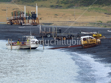 Launching a commercial fishing boat at Ngawi, Palliser Bay