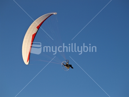 A powered hang glider flying above Haumoana, Hawke's Bay.