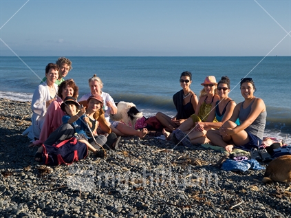 A group at Haumoana beach on a sunny morning in Hawke's Bay -  incorporating ethnic and generational diversity. 