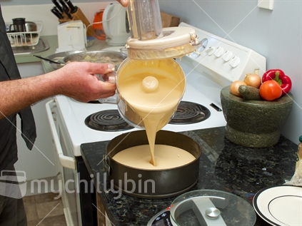 A persimmon cheesecake being prepared in a typical Kiwi kitchen (raised ISO)