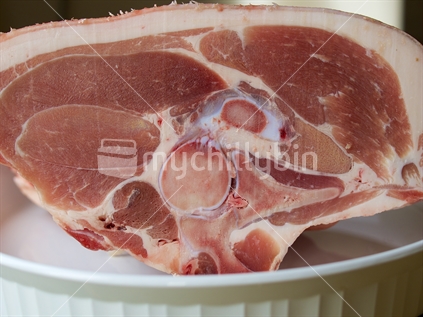 A leg roast of free-range, home-killed pork showing high fat content. 