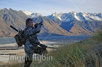 Hunter points out a spotted target, in the high country of New Zealand