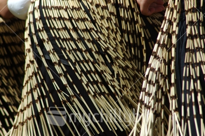 Detail of traditional costume on young woman performing a traditional Maori dance