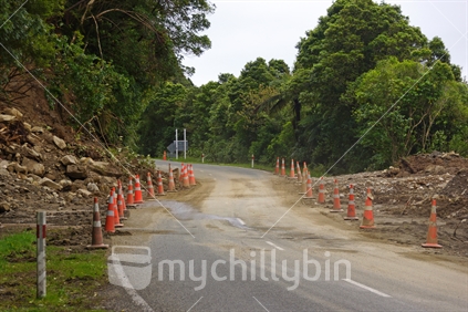 Traffic cones protexting landslip cleared temporarily from the road in the Buller Gorge, West Coast, South Island