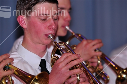 Brass band member playing a trumpet in live performance