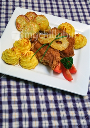 Evening canteen meal of roast chicken breasts, mashed potato, roast kumara, tomato and pineapple