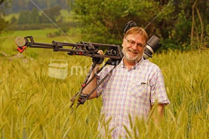 Cameraman at work in a wheat field