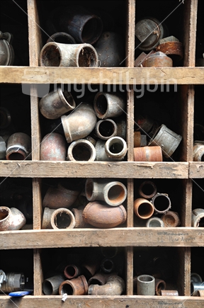 Old pipe fittings in their shelves