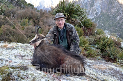 Hunter posing with Chamois buck, shot in the high country