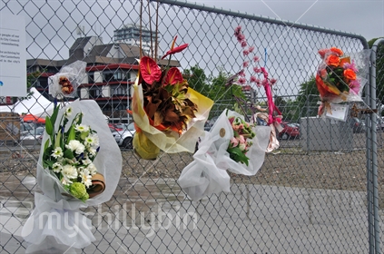 Fresh wreaths adorn a fence around the red zone in Christchurch, South Island, since the earthquake of 22-2-2011