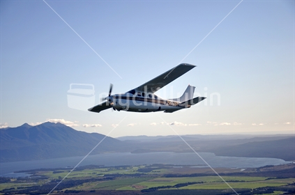 Cessna 210 pressurised passenger aeroplane above Lake Brunner