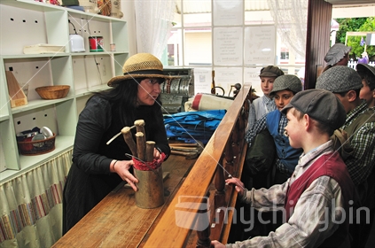Children buy their gold mining equipment from the store at Shantytown on an educational field trip