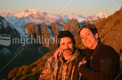 Mature couple enjoy an alpine sunrise at Mt Cook in South Westland