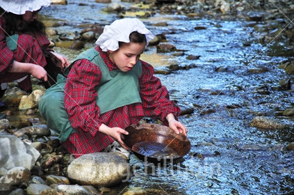 Girl panning for gold at Shantytown on an educational field trip