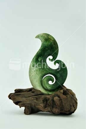 Jade carving set on a driftwood display stand, West Coast, South Island, New Zealand