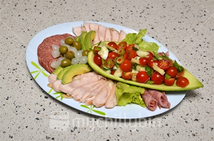 Plate of tempting salad vegetables and sliced meats