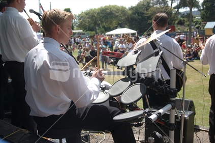 Man playing electronic drums in band at Waitangi Day picnic in Greymouth, West Coast