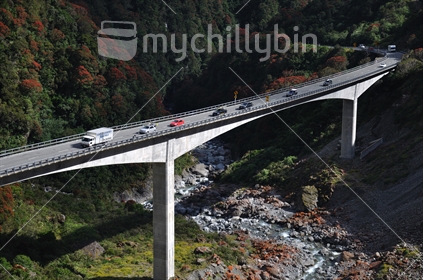 Vehicles on the Otira Viaduct in summer, West Coast, South Island, New Zealand.