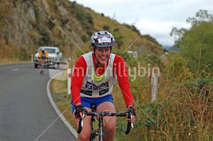Female competitor in the cycling leg of the 2007 Coast to Coast triathlon, Bealey district,  South Island