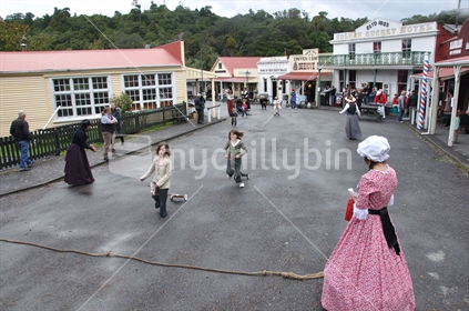 Children racing on hobby horses at Shantytown, Westland, South Island, during the 150th Westland celebrations in 2010