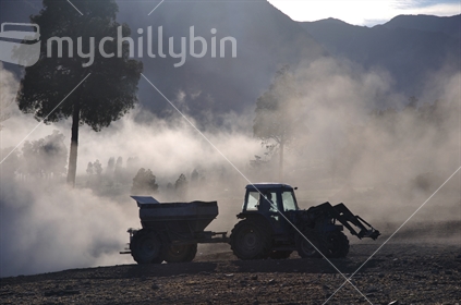 Tractor spreading lime with a fertiliser spreader, West Coast
